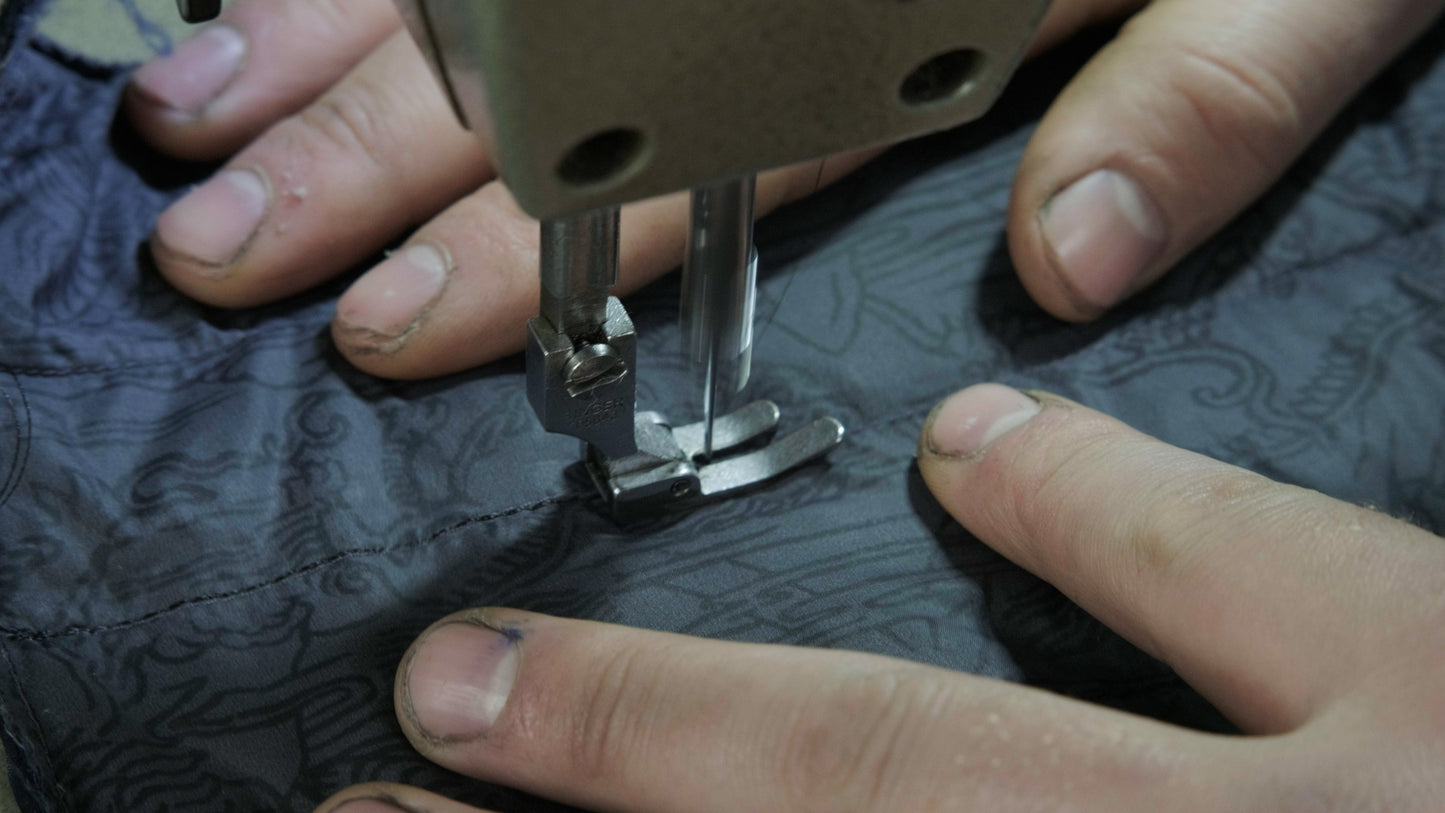 Summiteer Repair Shop - Repairing a down jacket with a new fabric panel.